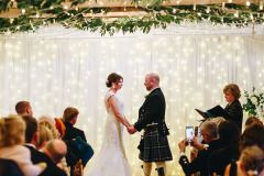 The wedding couple exchanging vows