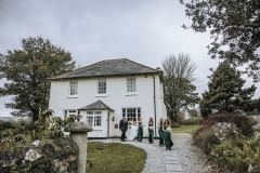 The bridal party making their way from the house to the wedding van