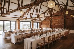 The red Brick barn set up with trestle tables