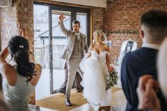 Couple entering the Red Brick Barn for the reception