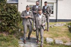 The groom and groomsmen making hteor way to the ceremony