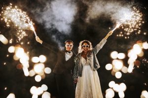 A couple celebrate their wedding with sparklers