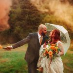 Couple with smoke bomb in autumn colours