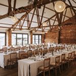 Trestle tables set up in the Red Brick Barn